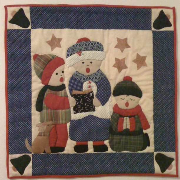 Quilted carol singers. Made by my mum, now on the wall of my flat. :D