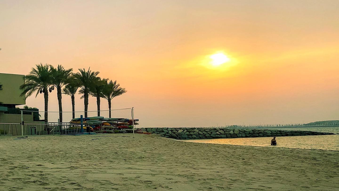 Beating the heat in Abu Dhabi with beach swim at sunset.