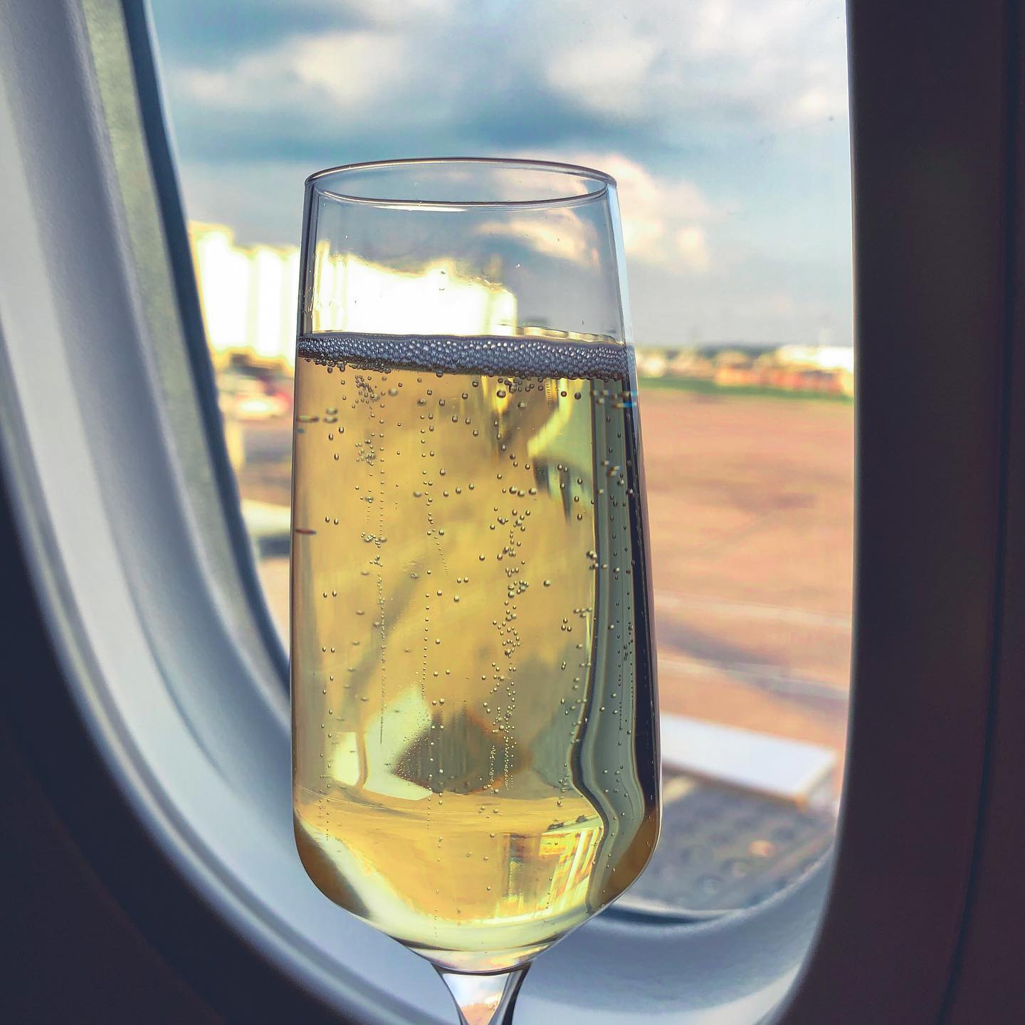 Obligatory “I’ve been upgraded” on-board champagne glass photo. 🍾