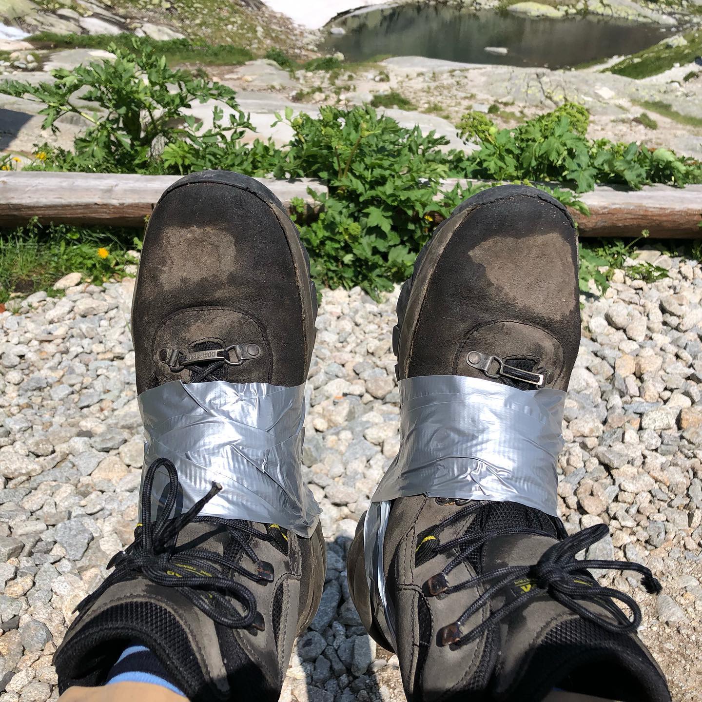 Emergency repairs to borrowed boots at 2000 meters.